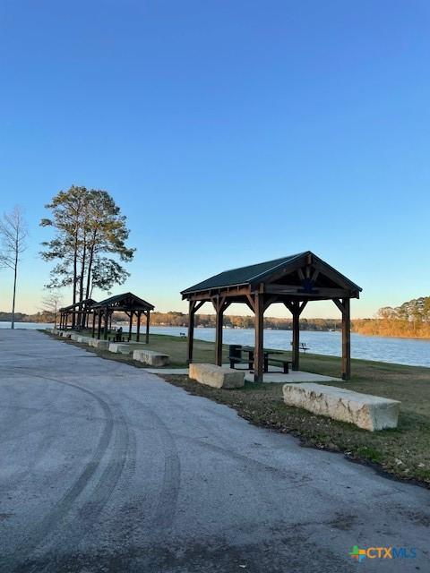 view of home's community with a gazebo and a water view