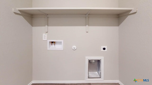 clothes washing area featuring washer hookup, hookup for an electric dryer, gas dryer hookup, laundry area, and baseboards