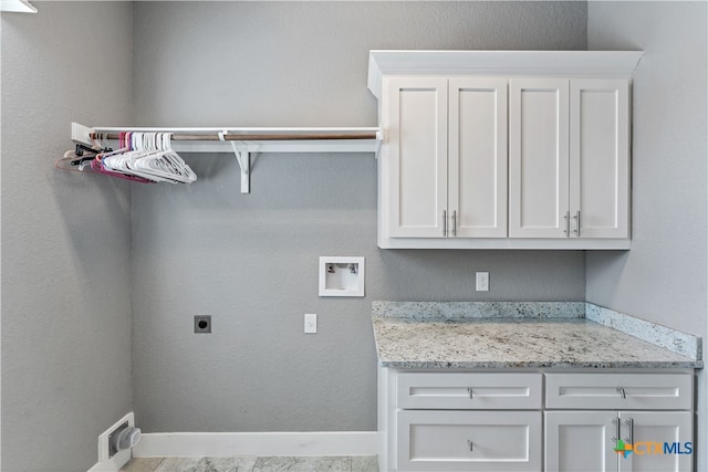 laundry area featuring cabinets, washer hookup, and electric dryer hookup