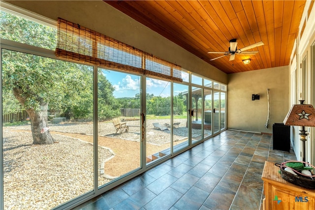 sunroom with wooden ceiling and ceiling fan