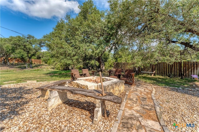 view of yard featuring a patio and a fire pit