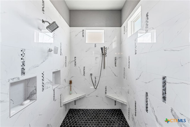 bathroom with a tile shower