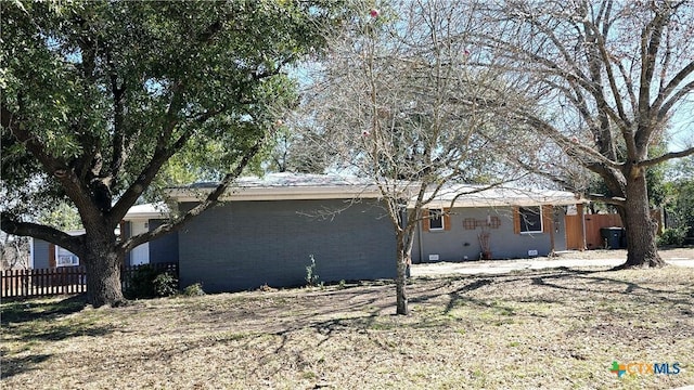 exterior space featuring fence and brick siding