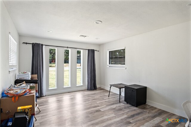 interior space with hardwood / wood-style flooring and a textured ceiling