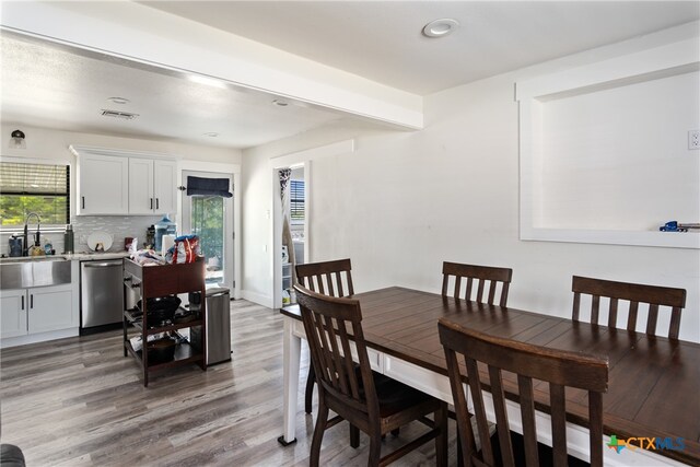 dining room with hardwood / wood-style flooring and sink