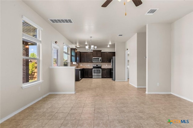 interior space featuring visible vents, light countertops, backsplash, and stainless steel appliances