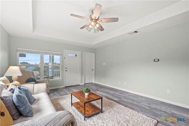 1110 Twin Deer Ln, Canyon Lake, TX 78133 - living room featuring a raised ceiling, wood finished floors, and ceiling fan