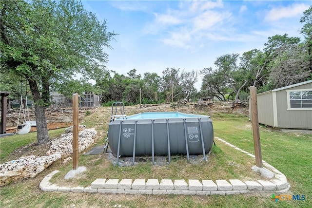 1110 Twin Deer Ln, Canyon Lake, TX 78133 - view of green lawn with an outdoor pool, view of wooded area, and an outdoor structure