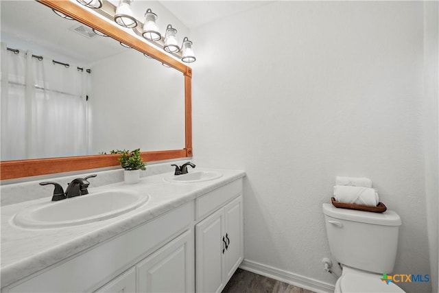 1110 Twin Deer Ln, Canyon Lake, TX 78133 - full bathroom featuring double vanity and wood finished floors