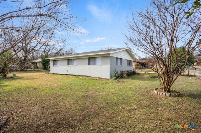 view of side of home featuring a yard