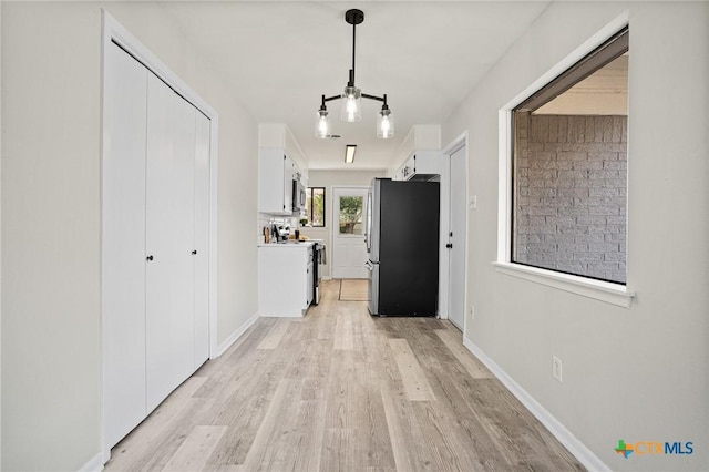 hallway featuring light hardwood / wood-style flooring