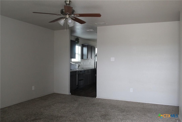 unfurnished living room with a ceiling fan, carpet, visible vents, and a sink