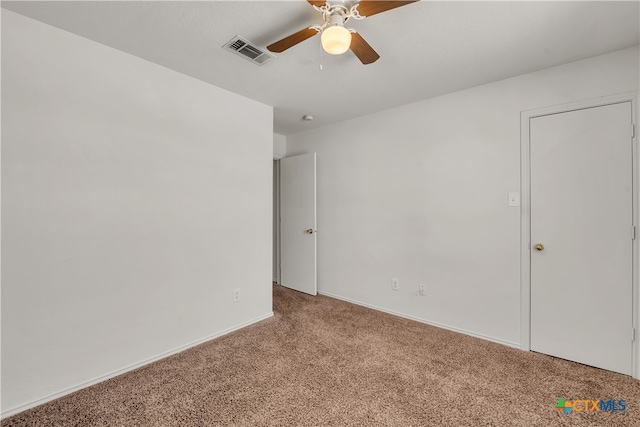 unfurnished room with ceiling fan and light colored carpet