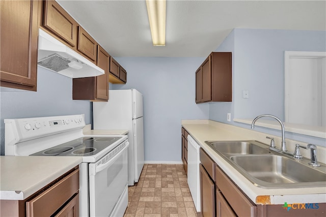 kitchen with kitchen peninsula, white appliances, and sink