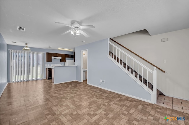 unfurnished living room with ceiling fan and light tile patterned flooring