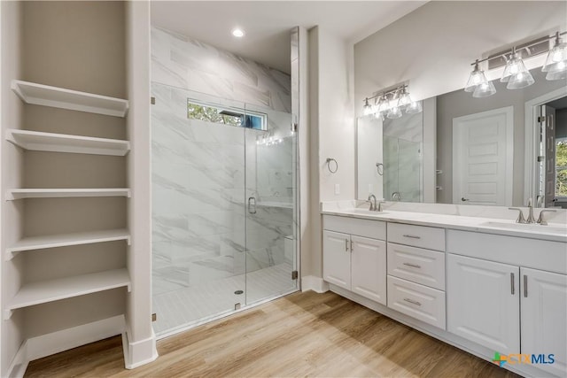 bathroom featuring vanity, hardwood / wood-style floors, and walk in shower