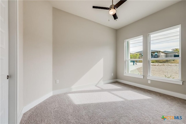 spare room featuring ceiling fan and carpet