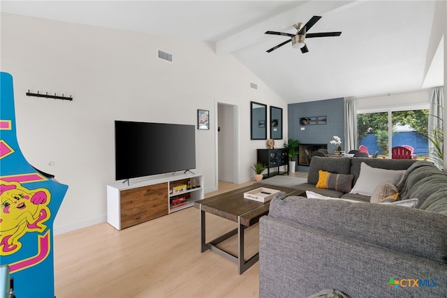 1107 Chesapeake Dr, Austin, TX 78758 - living room with beam ceiling, wood finished floors, ceiling fan, a fireplace, and baseboards