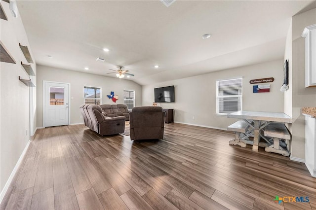 living room featuring hardwood / wood-style flooring, ceiling fan, and vaulted ceiling