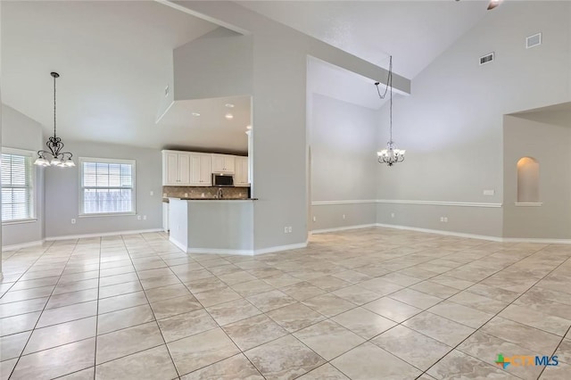 503 Wilderness Way, New Braunfels, TX 78132 - unfurnished living room featuring a chandelier, high vaulted ceiling, and light tile patterned floors