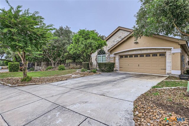 503 Wilderness Way, New Braunfels, TX 78132 - view of exterior entry with stone siding and a garage