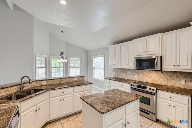 503 Wilderness Way, New Braunfels, TX 78132 - kitchen featuring stainless steel appliances, vaulted ceiling, tasteful backsplash, a chandelier, and dark stone countertops