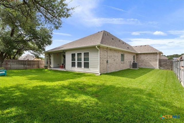 1330 Logan Blvd, Salado, TX 76571 - rear view of house with a fenced backyard, brick siding, and roof with shingles