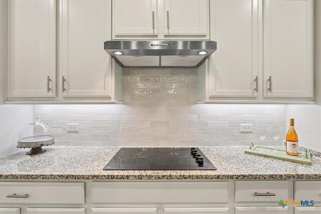 1330 Logan Blvd, Salado, TX 76571 - kitchen featuring range hood, black electric stovetop, and white cabinetry