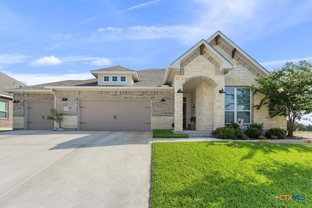 1330 Logan Blvd, Salado, TX 76571 - french country inspired facade with an attached garage, driveway, a front yard, roof with shingles, and stone siding