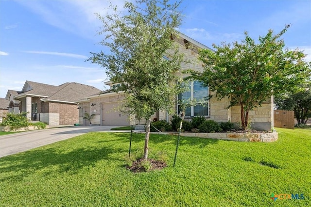 1330 Logan Blvd, Salado, TX 76571 - obstructed view of property with an attached garage, concrete driveway, and a front yard