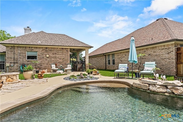 view of pool with a patio area and fence