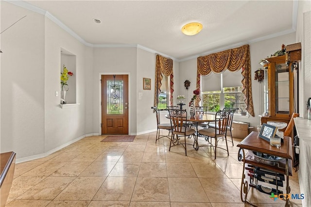 dining space featuring ornamental molding, baseboards, and light tile patterned floors