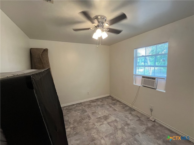 unfurnished room with cooling unit and ceiling fan