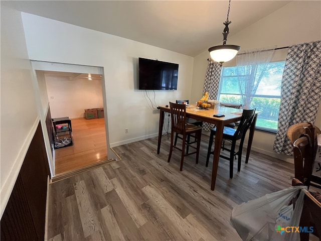 dining space with lofted ceiling and wood-type flooring