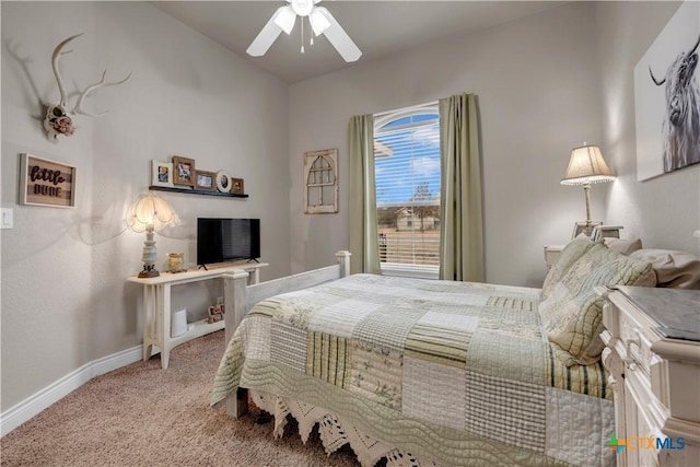 carpeted bedroom featuring baseboards and ceiling fan