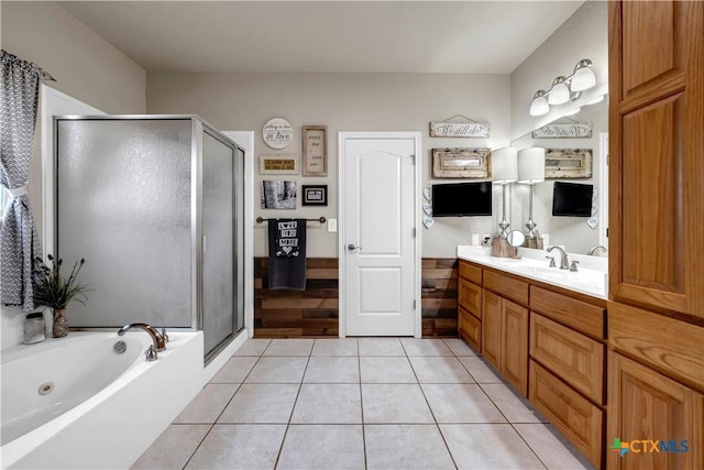 full bathroom with tile patterned floors, a jetted tub, a stall shower, and vanity