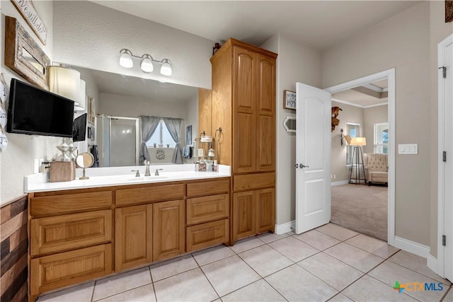 bathroom with baseboards, a stall shower, vanity, and tile patterned flooring