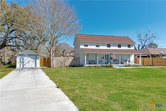 view of front of property featuring an outbuilding, fence, covered porch, a front lawn, and a detached garage