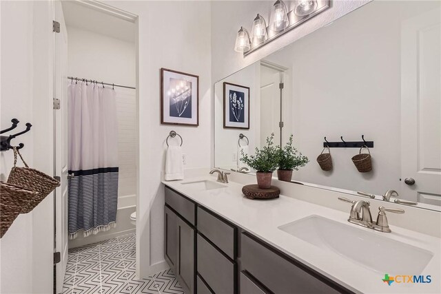 108 Rainbow Valley Trl, San Marcos, TX 78666 - full bath with double vanity, toilet, shower / bath combo, and baseboards