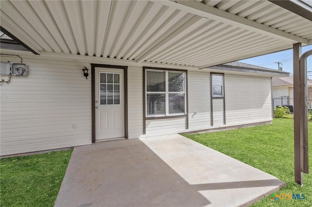 doorway to property featuring a yard and a patio