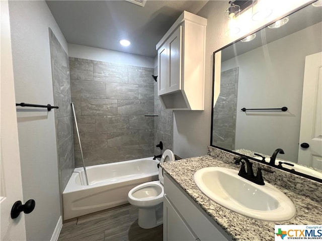 3827 Leming Ct, Temple, TX 76504 - bathroom featuring toilet, vanity, wood finished floors, tub / shower combination, and recessed lighting