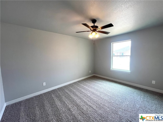 carpeted empty room featuring ceiling fan and a textured ceiling