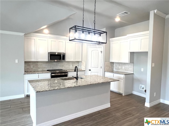 kitchen with dark wood-type flooring, light stone counters, white cabinets, an island with sink, and appliances with stainless steel finishes