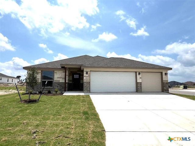 3827 Leming Ct, Temple, TX 76504 - prairie-style home featuring an attached garage, brick siding, concrete driveway, and a front lawn