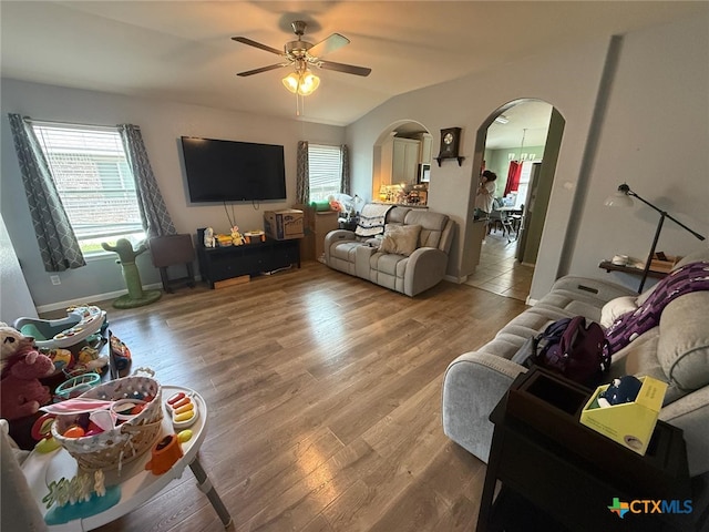 5629 Stonehaven Dr, Temple, TX 76502 - living area featuring arched walkways, a ceiling fan, and wood finished floors