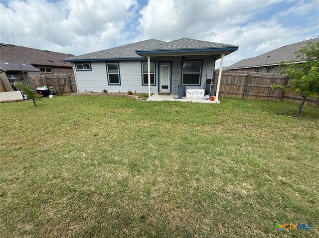 5629 Stonehaven Dr, Temple, TX 76502 - back of property featuring a lawn, a fenced backyard, roof with shingles, and a patio