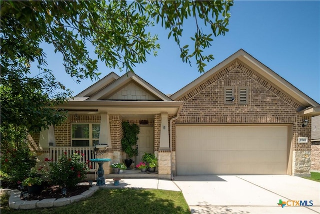 view of front of property featuring brick siding, a garage, concrete driveway, and covered porch