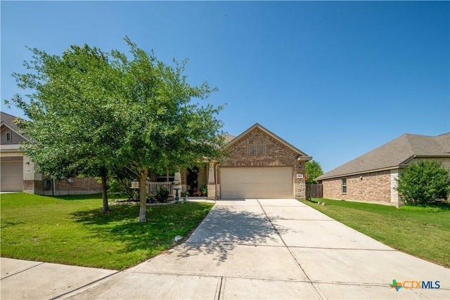 view of property hidden behind natural elements with brick siding, a front lawn, driveway, and an attached garage