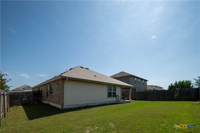 rear view of property with brick siding