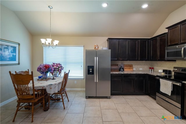 kitchen featuring stainless steel appliances, lofted ceiling, a chandelier, light stone countertops, and baseboards